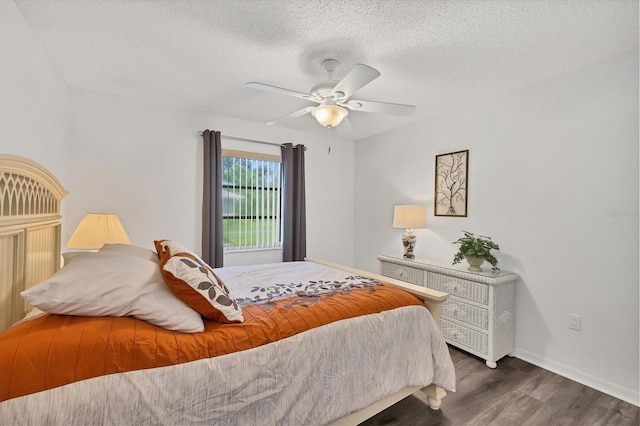 bedroom with dark wood-style flooring, ceiling fan, a textured ceiling, and baseboards