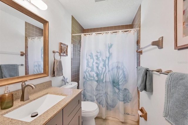 bathroom featuring curtained shower, vanity, toilet, and a textured ceiling