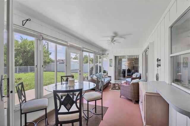 sunroom featuring french doors and ceiling fan