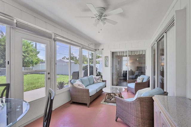 sunroom / solarium featuring ceiling fan