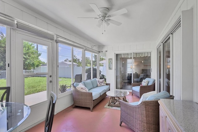 sunroom / solarium featuring a ceiling fan