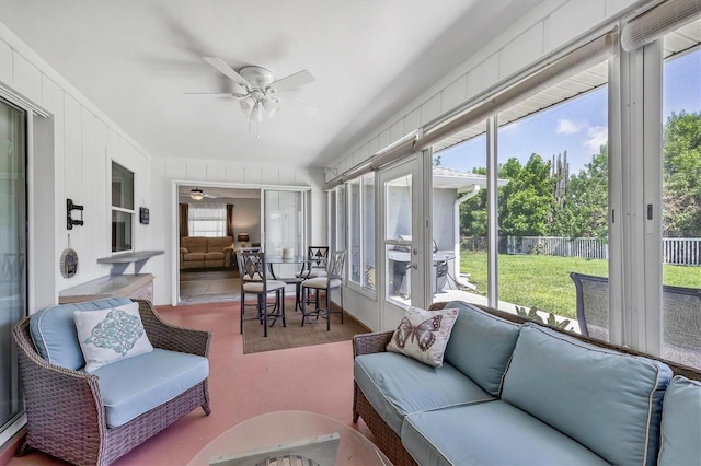 sunroom / solarium featuring ceiling fan