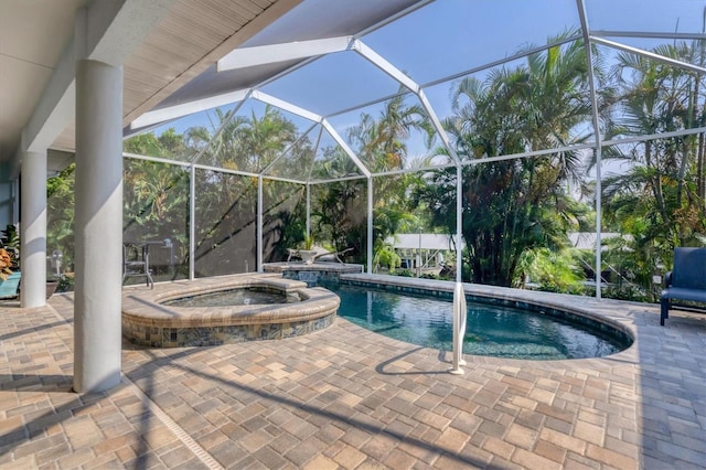 view of pool featuring a patio area, an in ground hot tub, and a lanai