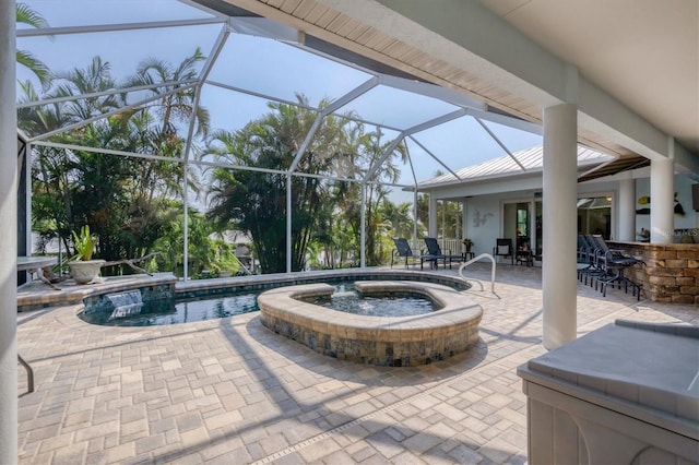 view of patio / terrace featuring a lanai, a bar, and a pool with hot tub