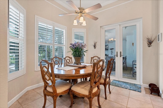 tiled dining area with ceiling fan, ornamental molding, and french doors