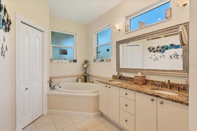 bathroom with vanity, tile patterned flooring, and a bath