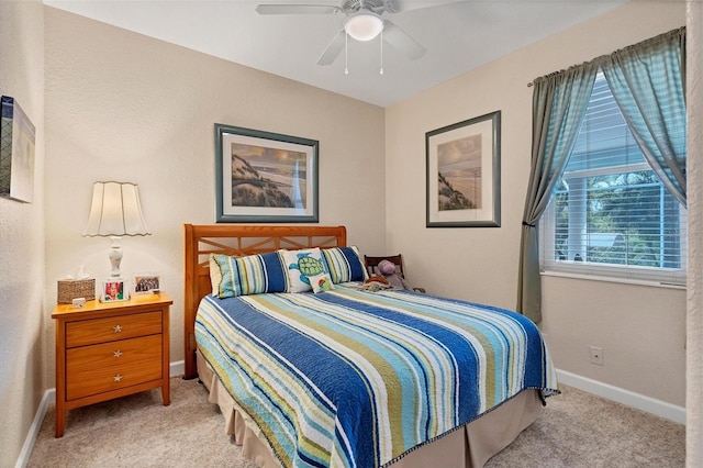 bedroom with ceiling fan and light colored carpet