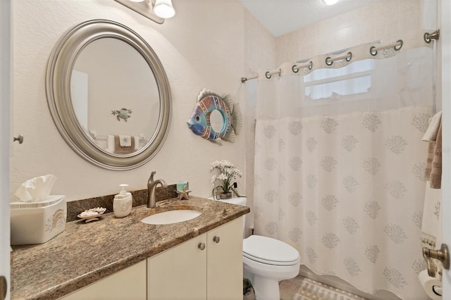 bathroom with toilet, curtained shower, and vanity