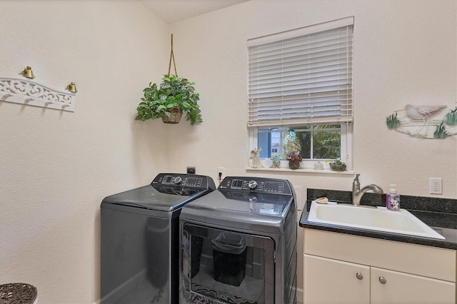 laundry room with sink, cabinets, and washing machine and clothes dryer