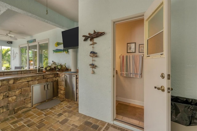 bathroom featuring ceiling fan and sink