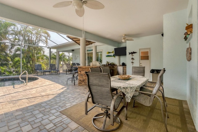 sunroom featuring ceiling fan