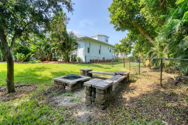 view of yard with a fire pit