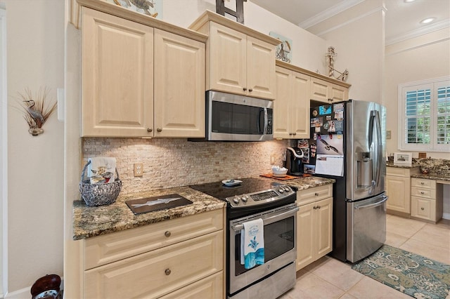 kitchen featuring ornamental molding, appliances with stainless steel finishes, dark stone countertops, and decorative backsplash