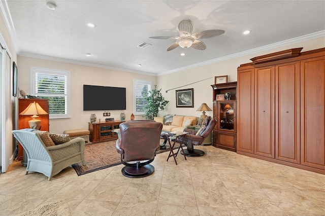 sitting room with a textured ceiling, ceiling fan, and ornamental molding