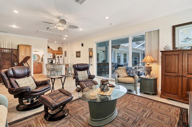 sitting room with ornamental molding and ceiling fan