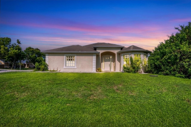 view of front of house with a yard