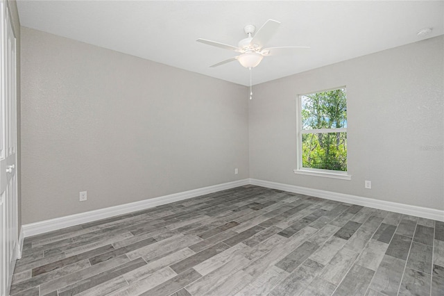 unfurnished room with ceiling fan and wood-type flooring