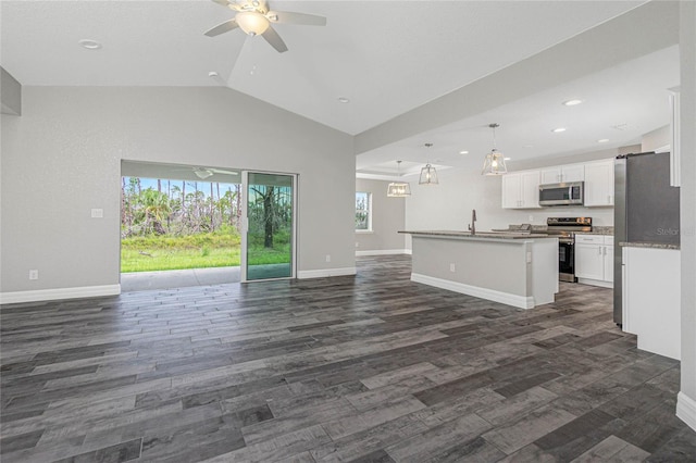 kitchen with dark hardwood / wood-style flooring, appliances with stainless steel finishes, a kitchen island with sink, hanging light fixtures, and white cabinets