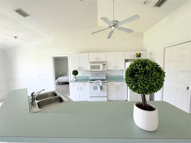 kitchen featuring white cabinetry, sink, high vaulted ceiling, white appliances, and ceiling fan