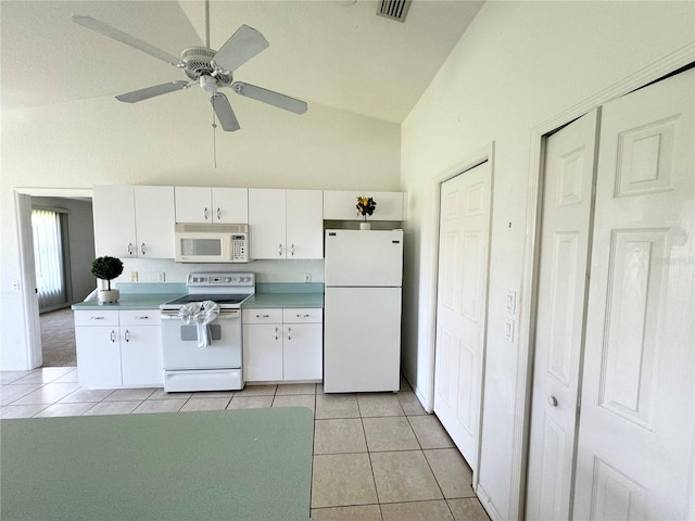 kitchen featuring vaulted ceiling, white cabinetry, white appliances, and light tile patterned floors