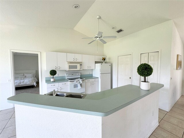 kitchen with white cabinetry, lofted ceiling, light tile patterned floors, white appliances, and ceiling fan