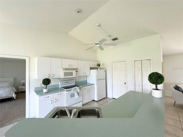 kitchen with ceiling fan, white cabinets, light tile patterned floors, sink, and white appliances