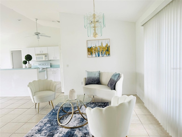 living room with ceiling fan with notable chandelier, high vaulted ceiling, and light tile patterned flooring