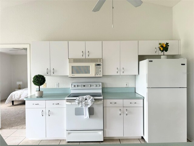 kitchen with ceiling fan, light tile patterned floors, and white appliances