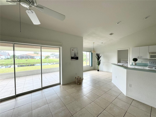 kitchen featuring white cabinetry, electric range oven, light tile patterned floors, ceiling fan, and hanging light fixtures