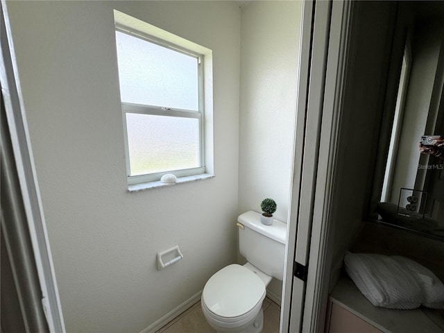 bathroom with tile patterned flooring and toilet