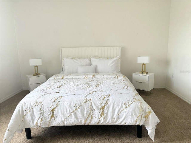 bedroom featuring dark colored carpet and baseboards