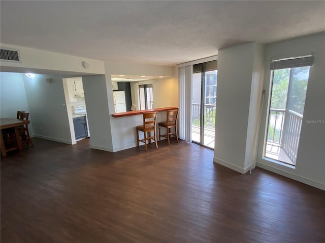 unfurnished living room with dark hardwood / wood-style flooring