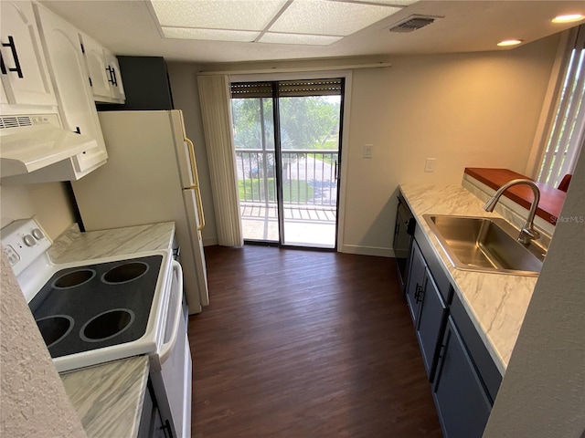 kitchen with white stove, sink, extractor fan, dark hardwood / wood-style flooring, and white cabinets