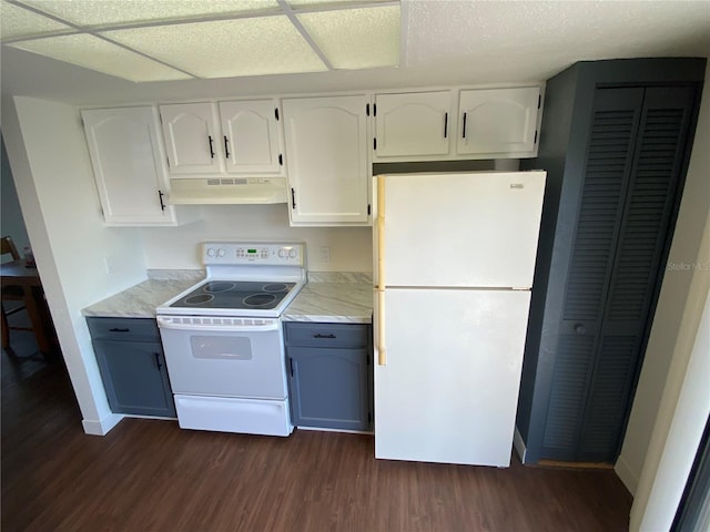 kitchen with white appliances, white cabinets, and dark hardwood / wood-style floors