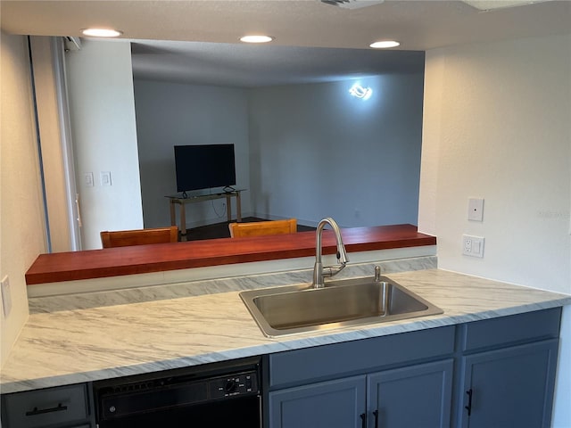 kitchen featuring sink, blue cabinets, and black dishwasher