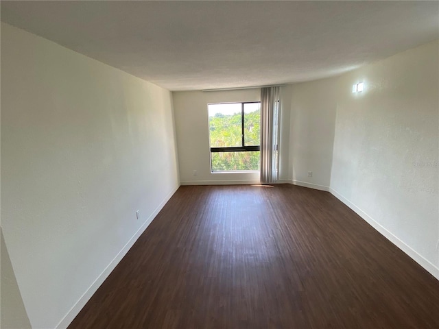 unfurnished room featuring dark hardwood / wood-style flooring