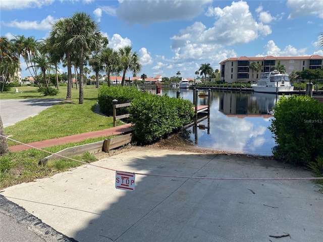 view of property's community featuring a yard and a water view