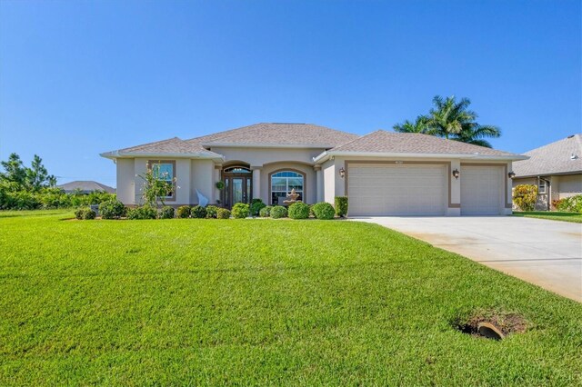 view of front of house with a front yard and a garage