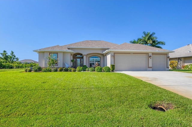 view of front of home featuring an attached garage, a front lawn, concrete driveway, and stucco siding