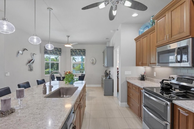 kitchen with appliances with stainless steel finishes, backsplash, sink, light tile patterned floors, and ceiling fan