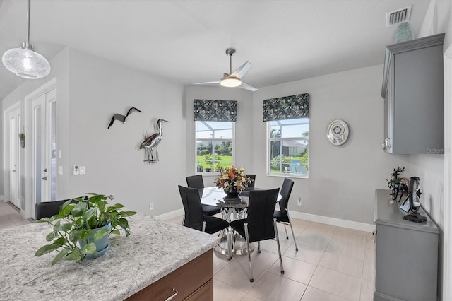 dining room featuring light tile patterned floors, baseboards, visible vents, and ceiling fan