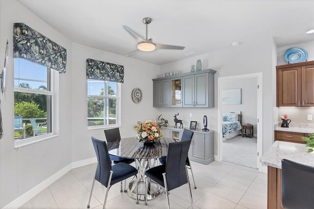 tiled dining space with ceiling fan