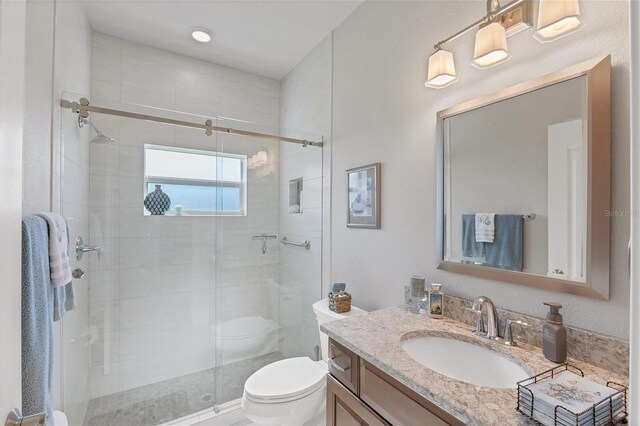 bathroom with an enclosed shower, toilet, and vanity