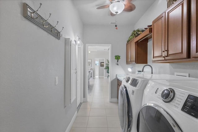 washroom with light tile patterned floors, cabinet space, visible vents, independent washer and dryer, and baseboards