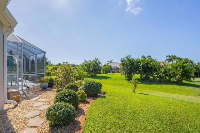 view of yard with glass enclosure