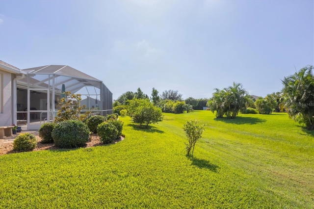 view of yard featuring glass enclosure