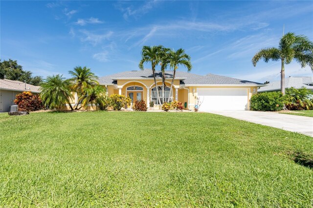 ranch-style home with a garage, a front lawn, and cooling unit