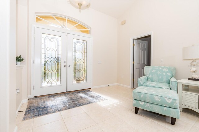 entryway with light tile patterned flooring and french doors