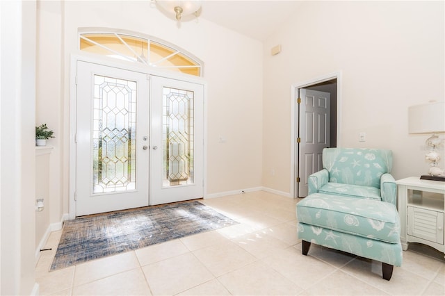 foyer featuring tile patterned flooring, a wealth of natural light, and french doors