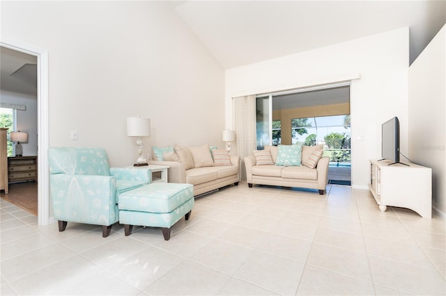 living room with high vaulted ceiling and light tile patterned floors